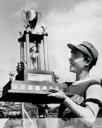 It's a beauty: Winning pitcher Harold Gray admires The Toronto Star Trophy that Toronto Playground East Peewee basebal team took at the CNE grounds yesterday