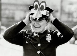 Just another fan: Police office Donna Stauffer, of the Inner Harbor Tactical Division, bends the regulations a bit by wearing a Baltimore Orioles Birdie beak over her hat