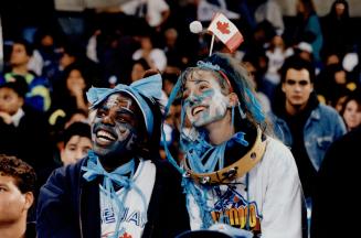 Grateful fans: Nicole Williams, 17, left, and Tanya Battalia, 18, are among the many Jays fans who skipped school - and work - for SkyDome celebrations