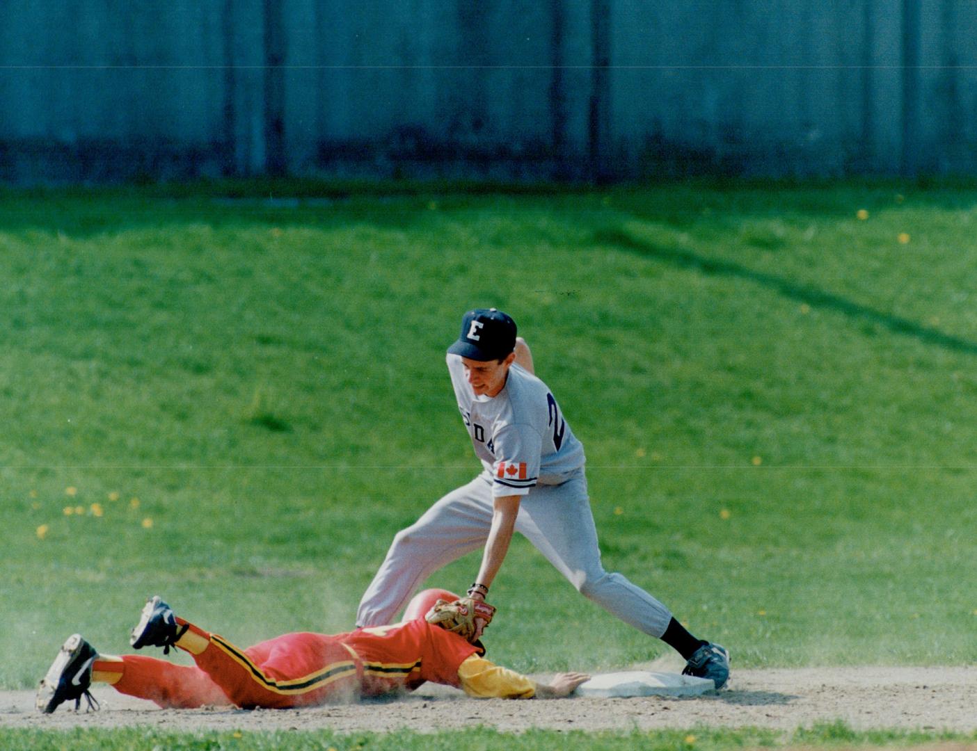 Tag day for ball teams? Eastdale Collegiate's BradReeson nails O'Neill Collegiate's Todd Dennis who was trying to stretch a double into a triple in a (...)