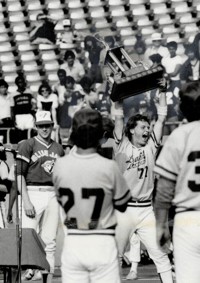 Metro champions: Leaside's John Novachis hefts the proof of Metro high school baseball supremacy after his two hits led to 3-1 victory over Parkdale at Exhibition Stadium