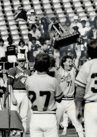 Metro champions: Leaside's John Novachis hefts the proof of Metro high school baseball supremacy after his two hits led to 3-1 victory over Parkdale at Exhibition Stadium