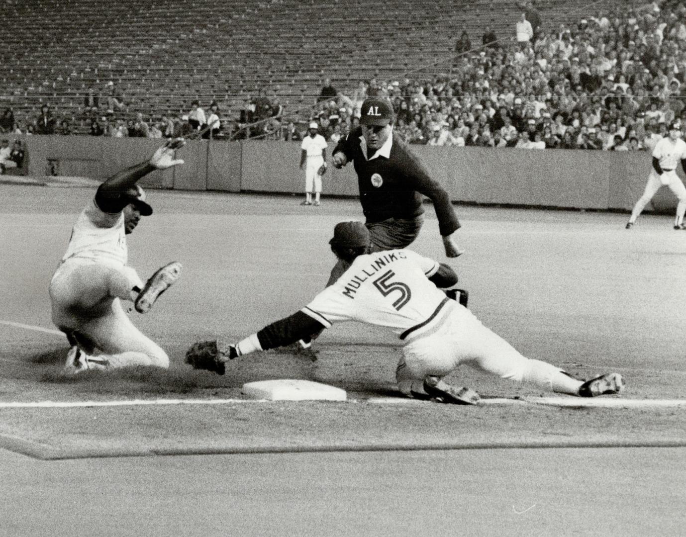 He's safe! It looks like Rance Mulliniks has Don Baylor out at third, but the Yankee designated hitter avoided the tag and was called safe by umpire R(...)