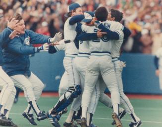 It's a wild charge to the mound as Jays converge on pitcher Doyle Alexander after their 5-1 victory clinched the East Division over the batting New York yankees