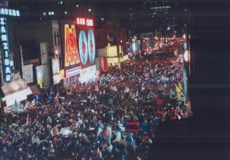 Street Party: Yonge St. was awash with jubilant fans, left, who partied well into the wee hours yesterday