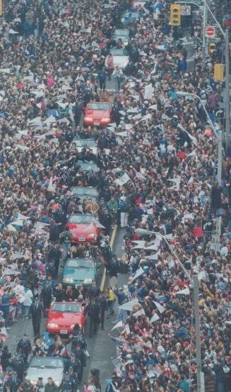 Parade of champions. Tens of thousands of fans line the way as the jays and their families drive to skydome on the monday following the final game for(...)
