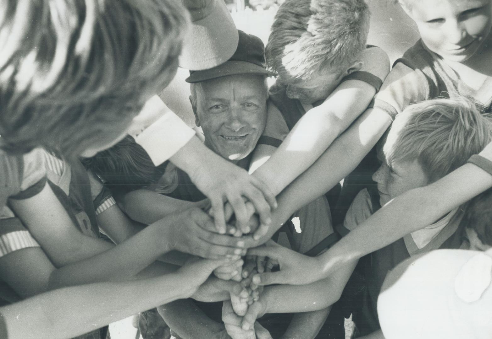 At the centre of attention and affection is 72-year-old Jim Christie, coach of the Mississauga Jets tykes softball team