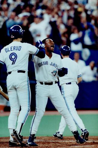 Say it's so, Joe: A jubiliant Joe Carter gets a high-five from John Olerud at SkyDome last night after blasting a home run in first inning to take a 1-0 lead against the Twins