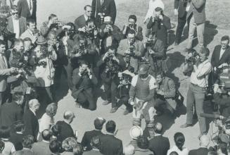 Montreal catcher John Bateman catches first pitch tossed out ley Quebec Premier Jean-Jacques Bertrand at bottom of picture next to mayor Jean Drapeau.(...)