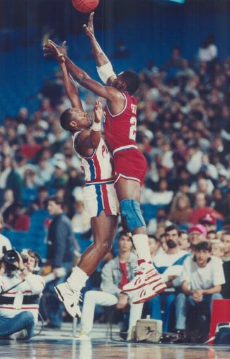 Guard Duty: Sixers guard Derek Smith takes the ball up and over Pistons guard Vinnie Johnson as he drives in for two points last night at the SkyDome