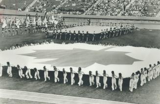 A huge Canadian flag is put together on centre field of the new Commonwealth Stadium in Edmonton during opening day rehearsal