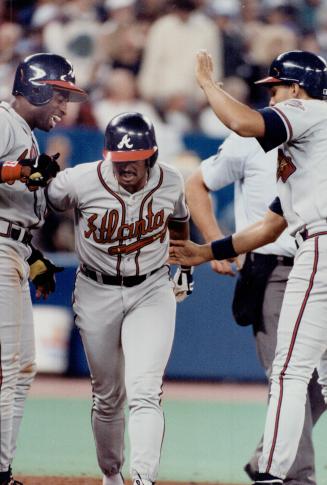 Mixed emotions: Jack Morris didn't feel so hot after Delon Sanders, Lonnie Smith and Dave Justice (left to right) celebrated Smith's grand slam in the fifth inning