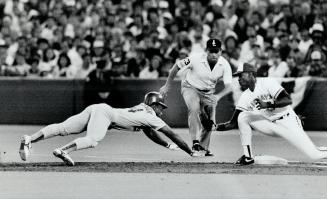 Stretch dive: Oakland's Rickey Henderson desperately reaches for first base as Jays' Fred McGriff gets set to apply the tag after a perfect pickoff toss by pitcher John Corutti yesterday