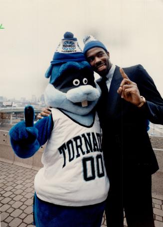 This tornado is a twister. Toronto Tornados' captain Gregory Hines hugs the team's new mascot, Twister, during a press conference yesterday. Tornados (...)