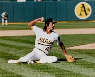While Reliever Dennis Eckersly (above) tries to throw out winfield after big Dave Knocked him over with smash to the mound