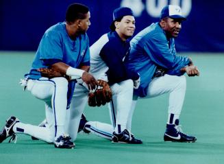Nice hat: Jay Candy Maldonado, left, comments on Robbie Alomar's backwards hat as Joe Carter joins them in a break at workout