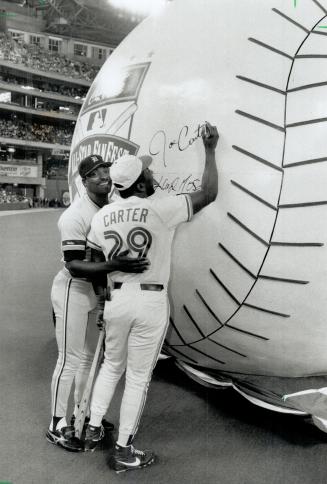 Charity Ball: Tigers' Lloyd Moseby, left, and Jays' Joe Carter sign the Fanfest Charity ball yesterday at the dome, kicking off a charity drive for children