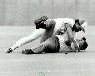 Super athlete Barfield had no trouble putting a wrestling hold on a laughing Merrill who was pinned to Exhibition Stadium's imitation grass for a three count