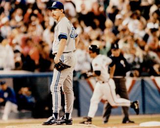 Brave belt: Jack Morris reacts as Atlanta's Damon Berryhill circles the bases after his Game 1 homer