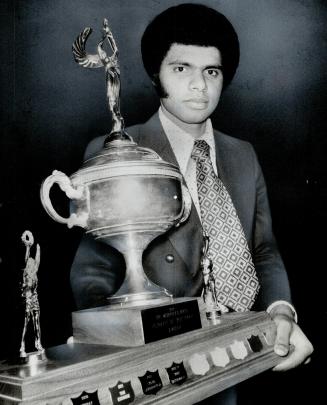 Ev Spence, member of York University's basketball and rugger teams, holds Murray Ross Trophy after being named school's top athlete of the year last night