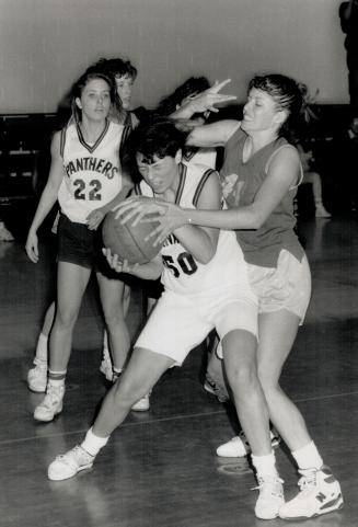 Holding on: Laura D'Aannibale of Cawthra Park is determined not to give up the ball to L'Naya Russell of Port Credit in Peel girls' basketball action as Tracy McCarthy looks on