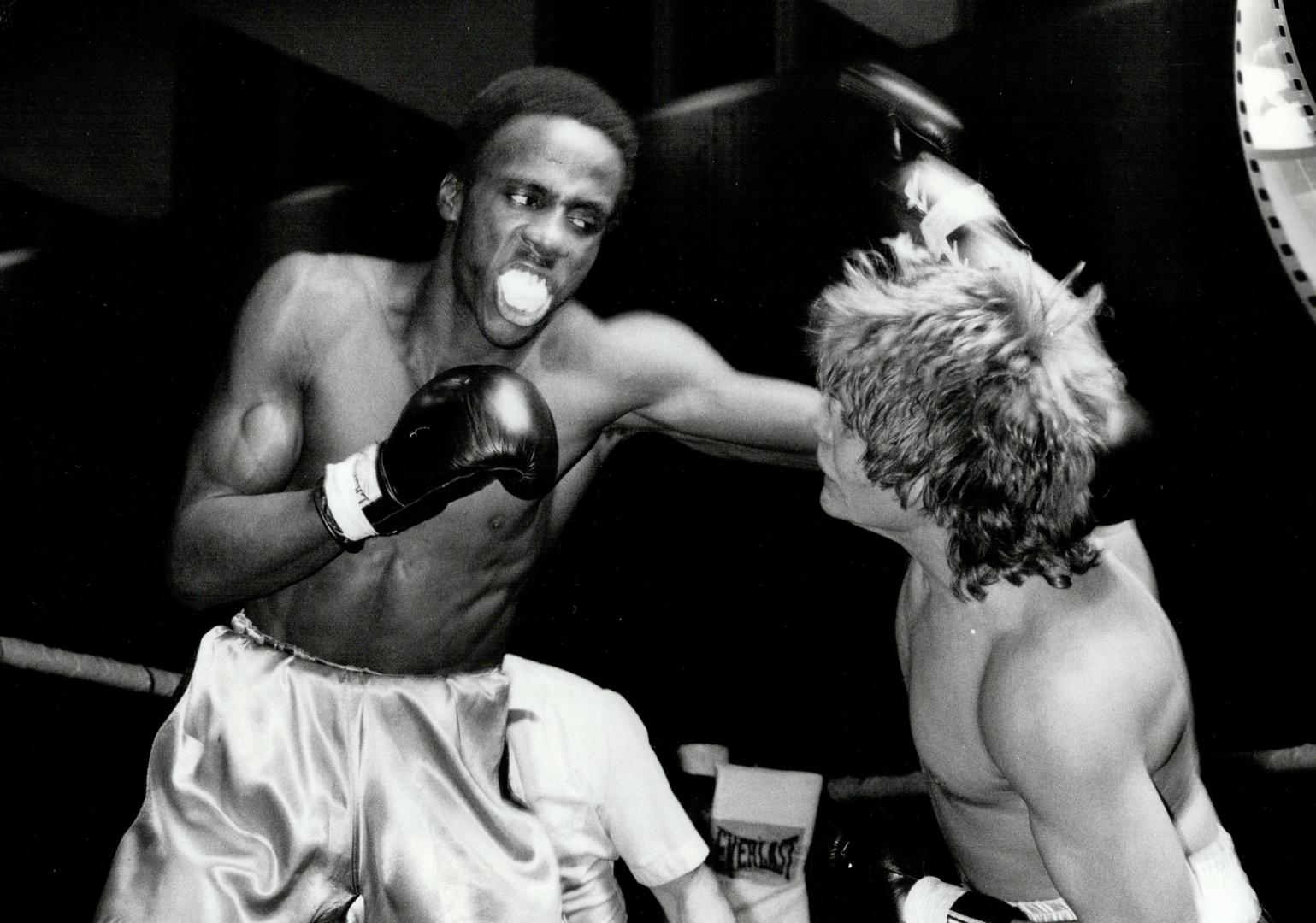 Tough way to make a living. Ralph Ward, left, is pummelling his way to a victory over Chuck Rowe, who seems to be taking considerable punishment in th(...)