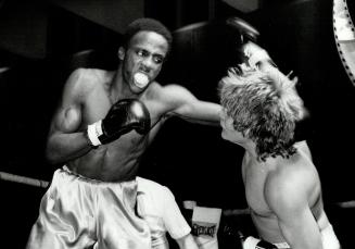 Tough way to make a living. Ralph Ward, left, is pummelling his way to a victory over Chuck Rowe, who seems to be taking considerable punishment in th(...)