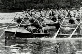 Together now. Mississauga Canoe Club paddlers pour it on in Dominion Day Regatta's juvenile war canoe race at Toronto Island
