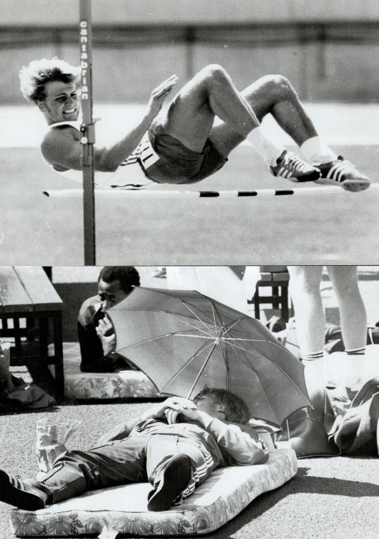 Edmonton. August 7th. Jump hard and rest easy. Ron Town (117) of Canada clears the jump and then rests under an umbrella in the noon day sun