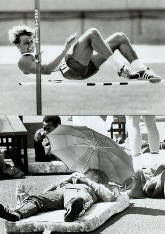 Edmonton. August 7th. Jump hard and rest easy. Ron Town (117) of Canada clears the jump and then rests under an umbrella in the noon day sun
