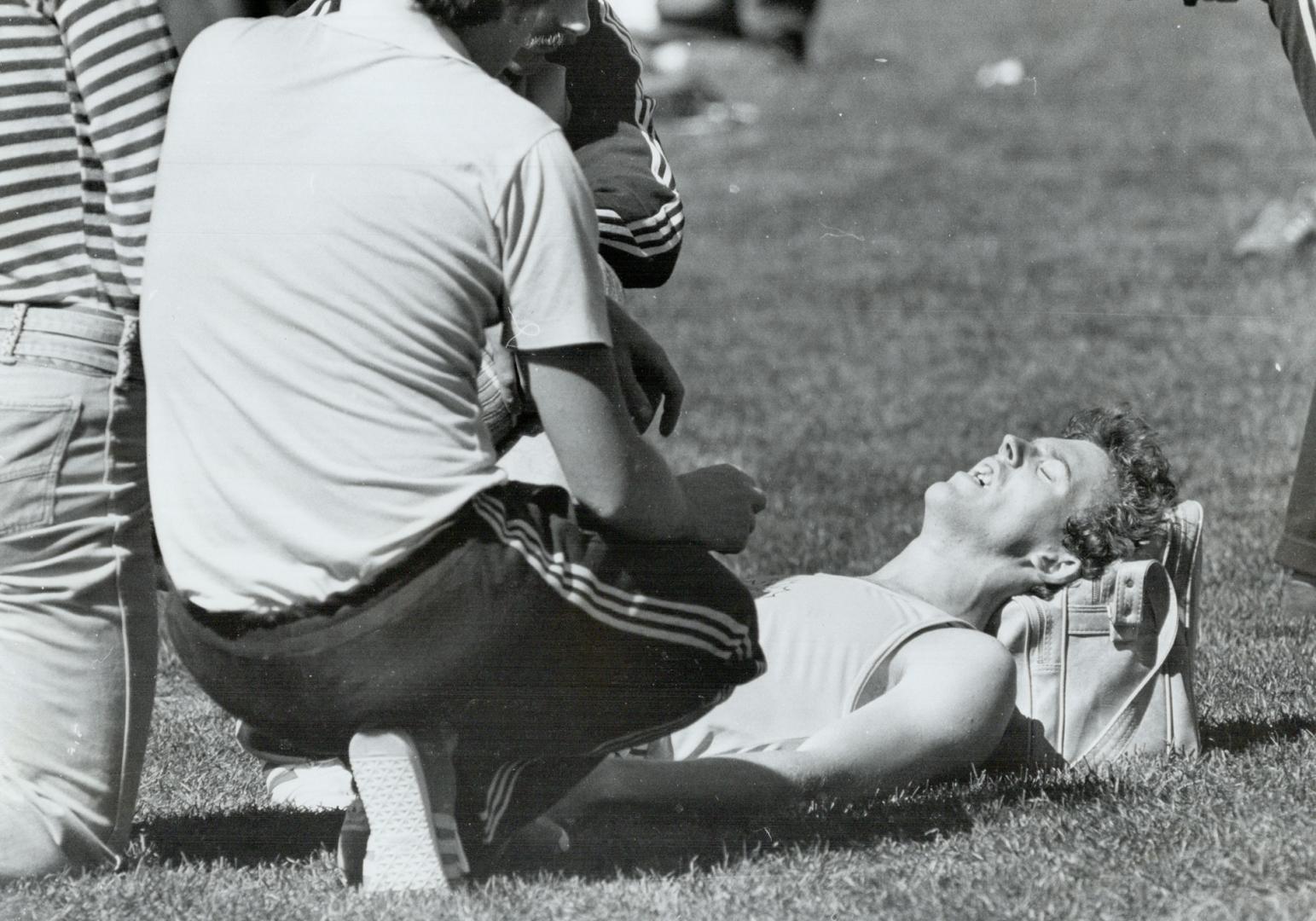 August 2nd. Edmonton. . .Part II of series. Frank Van Doorn lies on the ground writhing in agony and complaining that his back hurts after coming in second to Bowen in a 400 metre heat