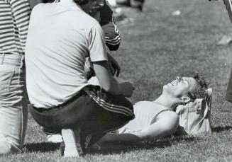 August 2nd. Edmonton. . .Part II of series. Frank Van Doorn lies on the ground writhing in agony and complaining that his back hurts after coming in second to Bowen in a 400 metre heat