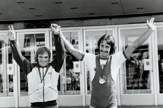 Weight Lifters. Darrell Schultz (Browze Medal) L, Michel Mercier (Gold Medal) R both Canadians winner V fon Victory