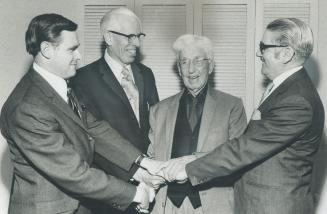 Still active in curling, at age of 94, retired Clergyman Duncan MacKeracher receives congratulations from fellow members of rink which was presented w(...)