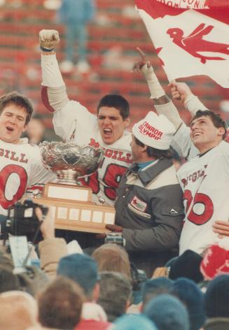 Minister of sport Otto Jelinek presents Vanier Cup to the McGill Redmen after their shocking 47-11 upset win over the UBC Thunderbirds yesterday. Line(...)