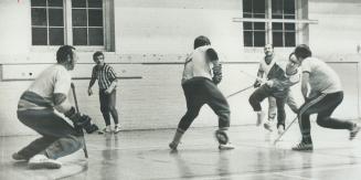 Stylish form is exhibited by Dave Todd of Jets as he unleashes shot at goalie Ken Kouch of Kings in Broadview YMCA floor hockey league game. Referee J(...)