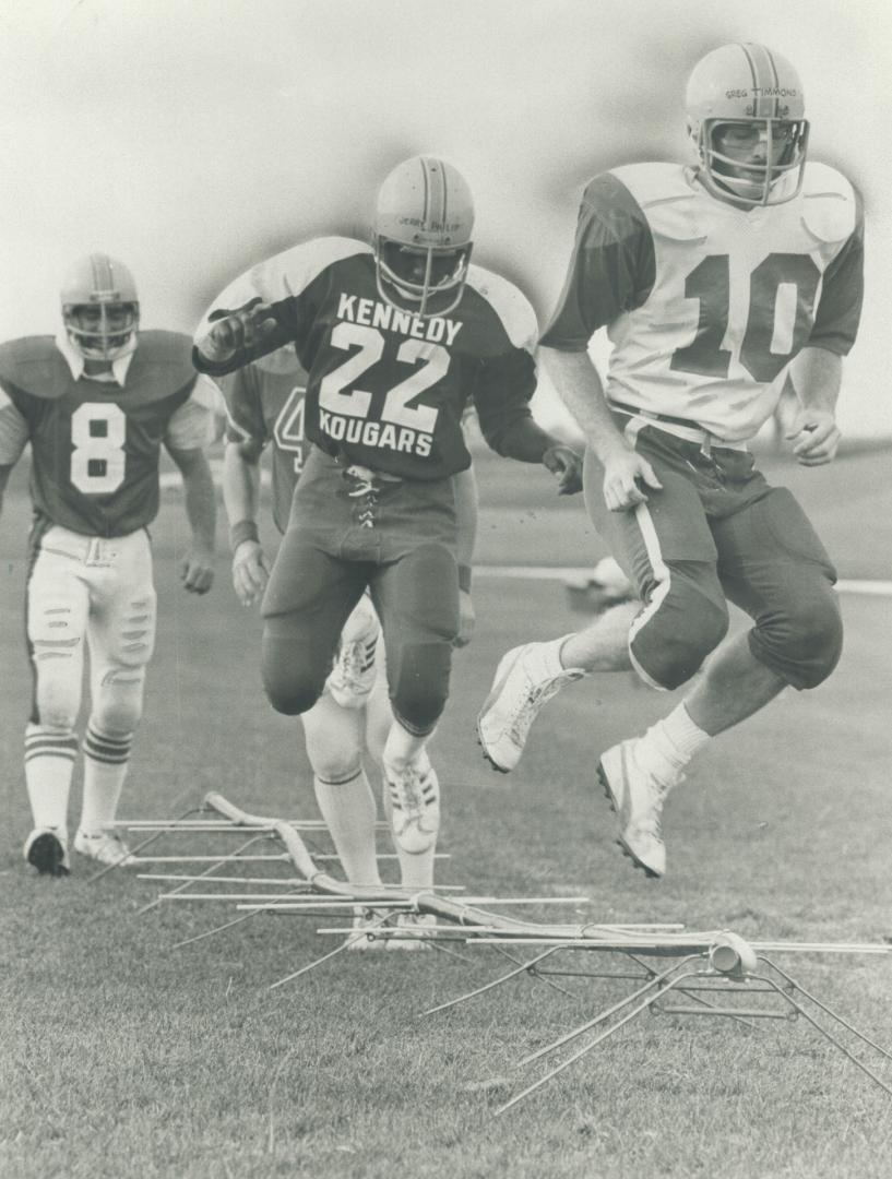 High-stepping Yeomen: Greg Timmons, right, and Jerry Philip lead the York Yeomen defensive backs through an agility drill during recent practice