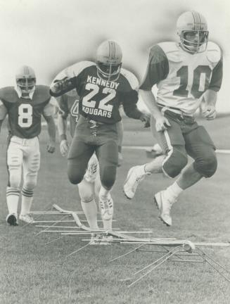 High-stepping Yeomen: Greg Timmons, right, and Jerry Philip lead the York Yeomen defensive backs through an agility drill during recent practice