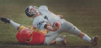 U of T quarterback Eugene Buccigrossi gets the turf treatment yesterday from Gryphon Pat Nield