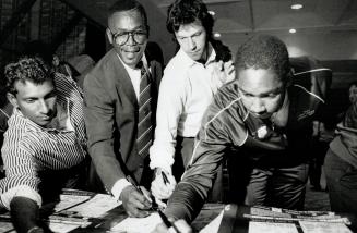 Bat men: Rest of the World stars (from left) Desmond Haynes, Imran Khan and an unidentified player sign posters in run-up to charity match today
