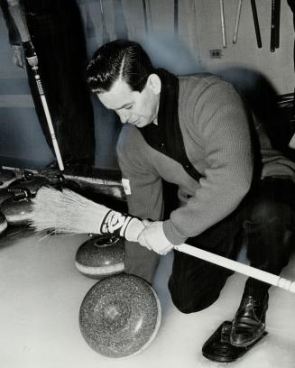 Ron Kemp cleans off rock. Hamilton Glendale curler prepares for shot