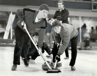 Study in concentration. A crouching Al Hackner watches his sweepers as he delivers a rock in his match against John Base in the Molson Classic at the (...)
