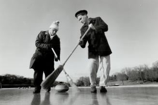 Test run: Organizer AL White, left, and High Park Curling Club manager Lundy Carre slap brooms as they try out the ice