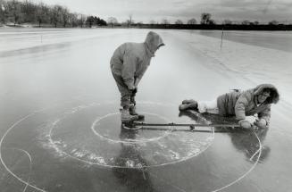 Roundabout: Don Powell holds the marker while John Wylie draws the house circles in preparation for bonspiel