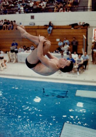Neat tuck: Billy Hayes of the Etobicoke Diving Club turned in a winning performance off the three-metre board in the invitational meet at Etobicoke Olympium and finished fourth in the one-metre test