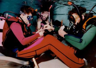 Peter Rijnieks, Cathie Tunney and Mike Briggs of the Toronto Super Turtles Dive Club enjoy a quiet game of cards underwater at the Wexford Collegiate (...)
