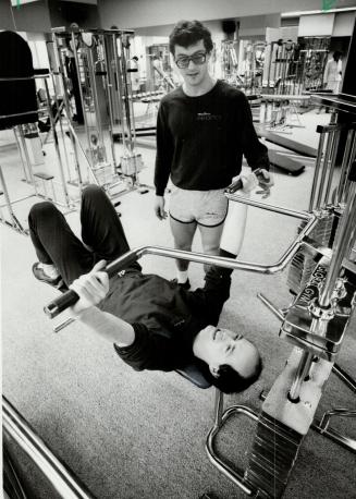 Torture chamber: Abandon pounds, all ye who enter here! Steve Allan instructs massage therapist Ronn Roses on the use of the bench press at Martin's