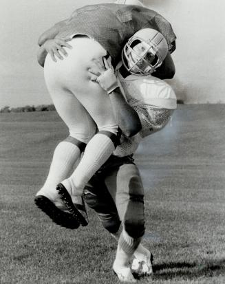 Carry on style: Mark Hopkins, a defensive linebacker with York University Yeomen and a top Canadian Football League prospect, takes part in some tackle practice with teammate George Ganas