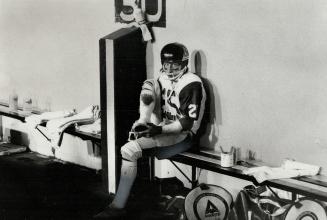 Lonesome: Fred Biletnikoff often sits pensively alone while teammates crowd sidelines to watch action