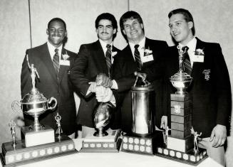 1984 Schenley Ciau Football Awards four winners - At table with trophies L to R - Larry Oglesby - President's Trophy, Phil Scarfone - Hec Crighton Tro(...)